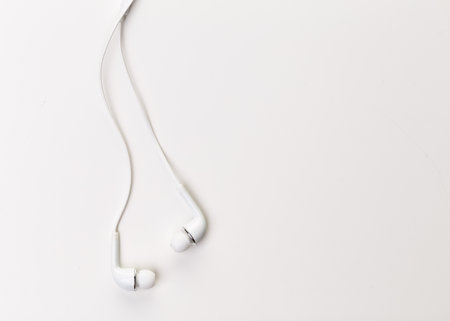 Pair of earphones close up on grey background