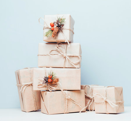 Decoratively wrapped holiday gifts stacked against a light background