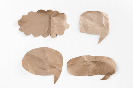 Creative paper speech bubbles arranged on a white background for communication conceptsの写真素材