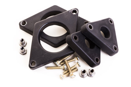 Collection of black rubber gaskets and metal bolts for various mechanical applications