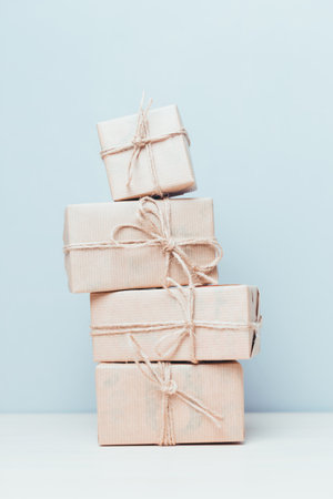 Beautifully wrapped gift packages stacked on a light backgroundの写真素材