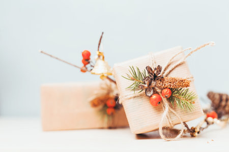 Decoratively wrapped gifts with natural elements on a light background creating a festive atmosphereの写真素材