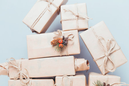Gifts wrapped in brown paper with natural decorations for a festive occasionの写真素材