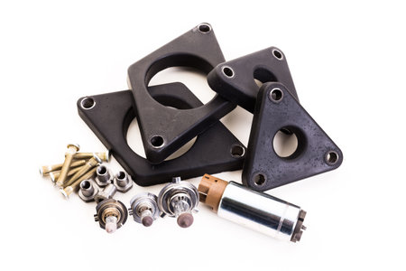Automotive parts collection with various gaskets, bolts, and a motor from a workshop