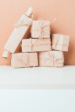 Gift packages stacked neatly against a brown backdrop in a cozy setting