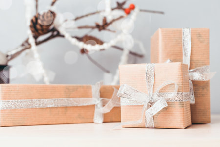 Gift boxes elegantly wrapped for a festive celebration with decorative elements in the background