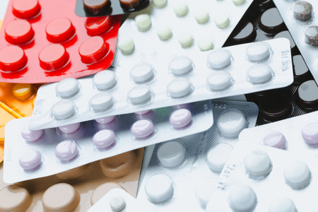 Various colored medication tablets arranged in a disorganized manner on a surface