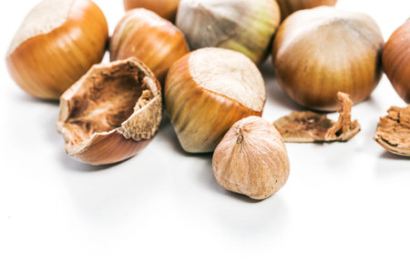 Shelled and unshelled hazelnuts arranged on a clean surface showcasing their natural colors