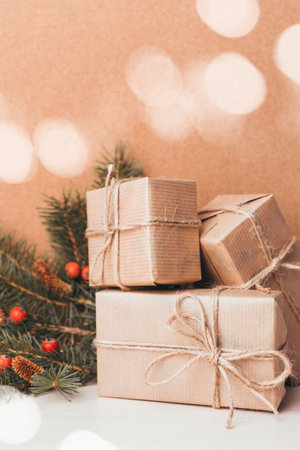Festive wrapped gifts arranged with pine branches and berries for a holiday celebration