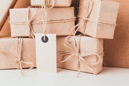 Wrapped brown boxes stacked with twine and labels ready for delivery in cozy setting