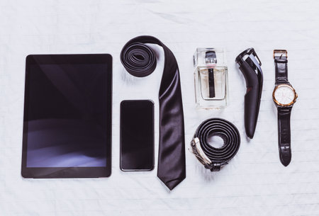 Grooming essentials and accessories arranged flat on a surface for a stylish look