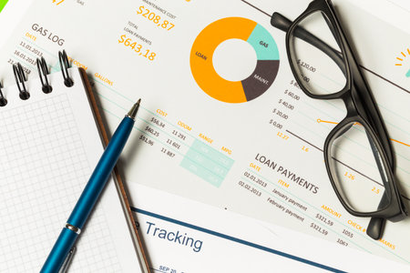 Financial documents and tools arranged neatly on a desk for analysis and planning