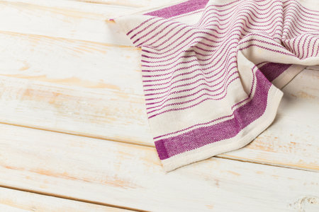Dish towel with purple stripes on a wooden table during daytimeの写真素材