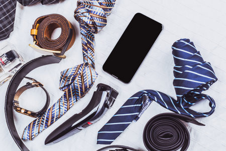 Mens accessories and grooming tools laid out on a table before an event or formal occasion