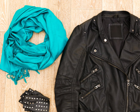 Fashion accessories laid out on a wooden floor for a stylish fall outfit ideaの写真素材