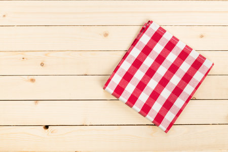 Red and white checkered tablecloth on a wooden table