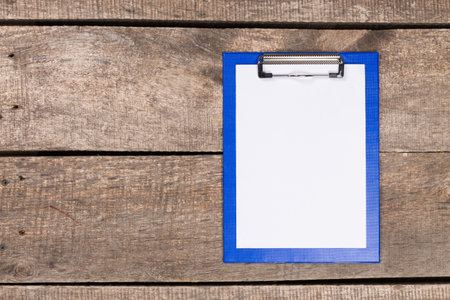 Clipboard resting on a rustic wooden surface ready for notes and sketches