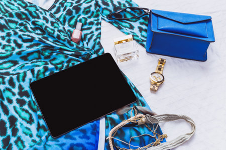 Fashion accessories and essentials arranged for a stylish outing in a chic setting