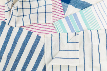 Various striped kitchen towels displayed in a flat lay arrangement on a surface