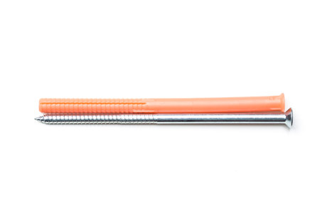Fasteners laid out on a white background showcasing a nail and a screw