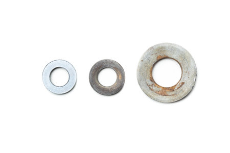 Different sizes of metal washers arranged in a row for comparison
