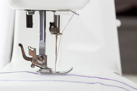 Close view of sewing machine needle at work on fabric during crafting project
