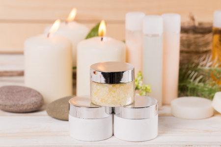 Natural spa products displayed with candles and stones for relaxation and wellnessの写真素材