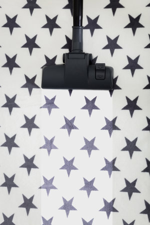 Black and white stars pattern with a vacuum attachment in an indoor setting