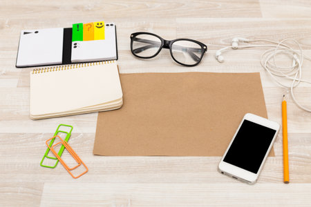 Workspace setup with stationery, mobile phone, and glasses ready for study or brainstorming