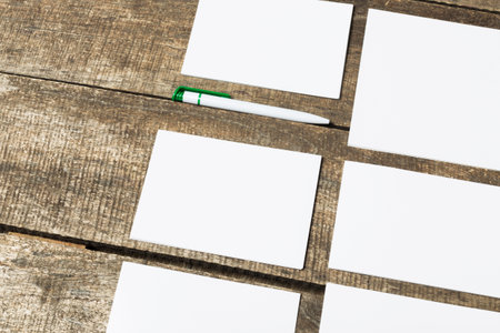 Blank cards and pen on a rustic wooden table for creative writing activities