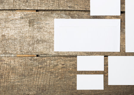 Blank white cards arranged on rustic wooden surface for creative design ideas