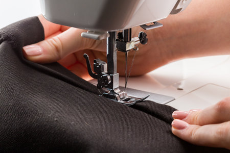 Sewing machine in use for crafting clothing with precision and care during daylight hours