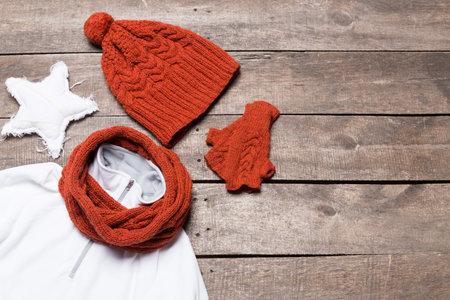 Warm winter accessories arranged on a rustic wooden table for a cozy seasonal look