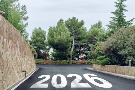 Road leading to the future with 2026 painted on the asphalt in a green setting