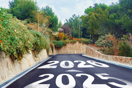 Road leading into the future with the years 2025 and 2026 painted on the asphalt