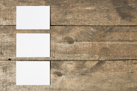 Blank cards arranged on a wooden surface in an organized manner for creative use