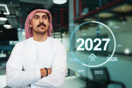 Business professional looking ahead to 2027 with confident posture in a modern office environmentの写真素材
