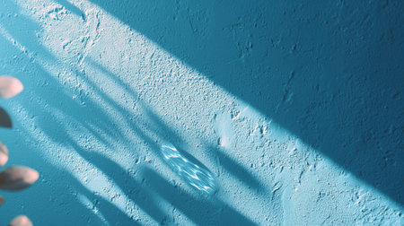 Bright blue wall with shadows and light creating an artistic patternの素材
