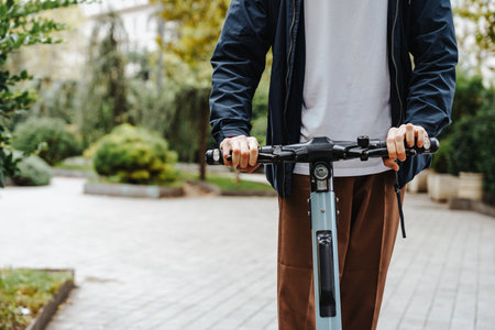 Person riding electric scooter in urban park during daytimeの写真素材