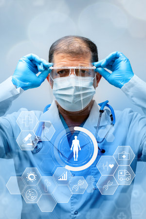 Healthcare professional prepares for patient care with protective equipment and technologyの写真素材
