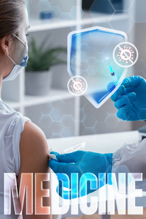 Healthcare worker administers vaccine to patient in modern clinic settingの写真素材