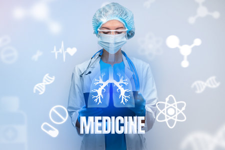 Healthcare professional in a lab coat and mask holding a tablet with medical symbolsの写真素材