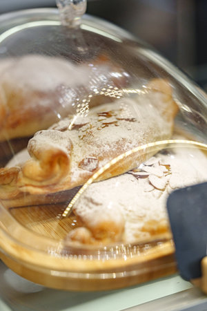 Pastries displayed under glass at a bakery in the afternoon light