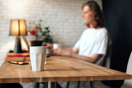Coffee brewing conversation in a cozy cafe setting during afternoon hoursの写真素材