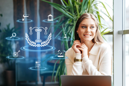 Young woman smiles near legal icons and plants indoorsの写真素材