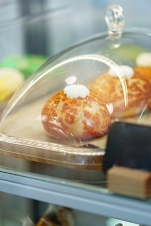 Freshly baked pastries displayed under glass in a cozy bakery counter