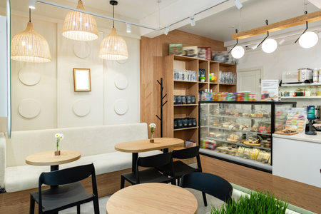 Cozy cafe interior with wooden furniture and a well-stocked display case