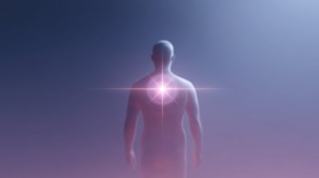 Silhouette of a person standing with a glowing light at the back in a misty atmosphereの素材