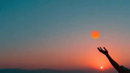 Sunset silhouette of a person reaching out towards the horizon during twilight hoursの素材