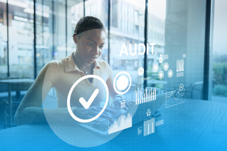 Professional conducting an audit using a digital device in a modern office settingの写真素材